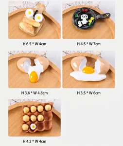 Detail showing 3D resin magnets of fried eggs, panda pan and egg tray miniatures