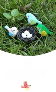 Miniature resin birds and nest with eggs set in moss landscape garden decoration