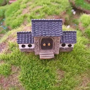 Miniature Chinese courtyard building model with grey roof and traditional stone walls