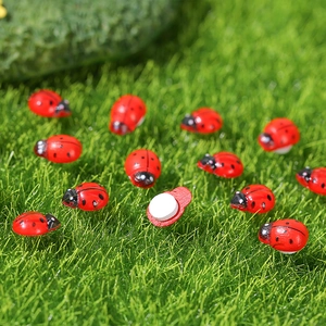 Mini wooden ladybug ornaments with adhesive backing on green moss for DIY crafts