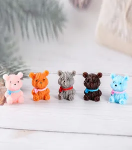 Macro detail of five resin miniature bears with knitted texture and colorful scarves