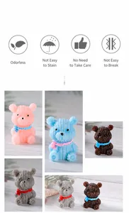 Detailed view of resin bear figurines with knitted texture and colorful scarves