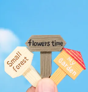 Detail of resin garden signs with 'flowers time' and 'my garden' text for succulents