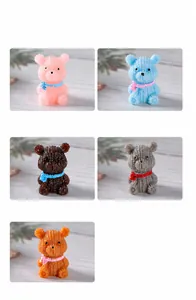 Detail view of five resin bears with knitted texture and colorful scarves for miniatures
