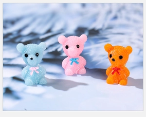 Close-up of three colorful resin bear miniatures with detailed fur texture for DIY decor
