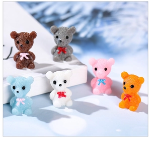 Macro shot of colorful resin bear figurines with bowties for DIY terrarium decor