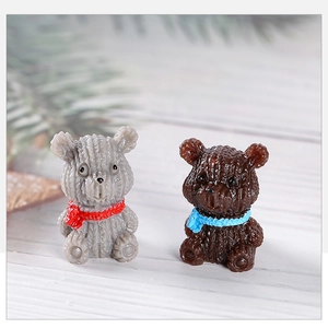 Close-up of resin mini bears with knitted textures on a rustic wood background