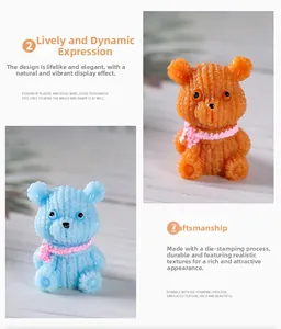 Detailed close-up showing knitting texture and pink scarf on blue resin bear ornament