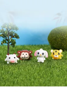 Miniature resin cartoon animals set including white rabbit and tiger on green moss