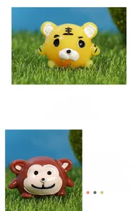 Detailed close-up of cartoon tiger and monkey resin figurines with glossy finish