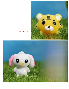 Detail of cute resin micro landscape ornaments featuring cartoon tiger and bunny on grass