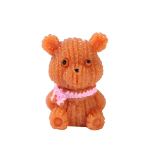Miniature resin bear figurine with orange knitted texture and pink scarf for garden decor