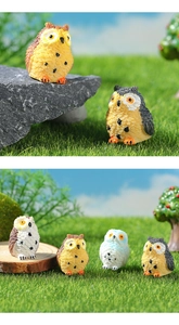 Detailed view of four colorful miniature resin owls with realistic feather textures