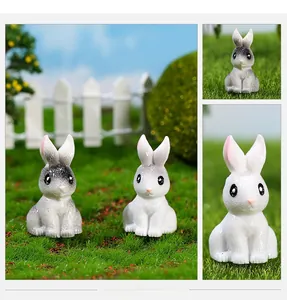 Close-up of resin miniature rabbits with realistic textures in a micro landscape setting