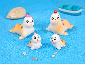 Detailed macro view of four different cartoon resin seal figurines for desk decor