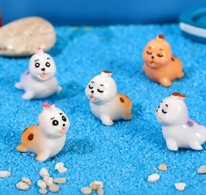 Detailed set of 5 miniature resin seals on blue sand base for ocean micro landscape
