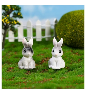 Detailed view of two cute miniature resin rabbits for succulent micro landscapes