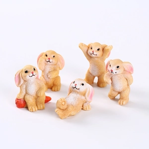 Detailed view of five cute resin bunny figurines in various playful poses for gardening