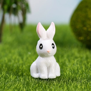 Cute miniature resin rabbit figurine on green grass for micro landscape and garden decor
