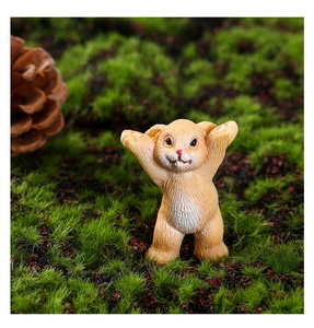 Macro shot of a cute orange resin bunny figurine with fur texture in a mossy forest setting