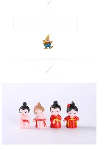 Detail of 4-piece mini resin couple figurines with vibrant traditional outfits for micro landscapes