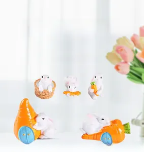 Close-up of 5-piece miniature resin rabbit set with carrots for succulent pot decor