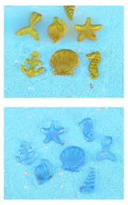 Detail view of resin ocean charms with starfish and seashell patterns in blue and yellow
