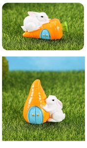 Detailed macro view of two cute resin bunnies resting on bright orange carrot micro houses