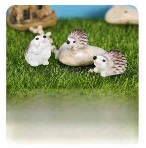 Detailed view of three resin hedgehog figurines on artificial grass for garden decor
