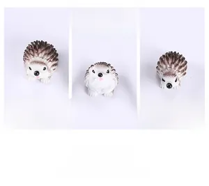 Close-up of cute hedgehog resin figurine showing detailed spikes and facial expressions