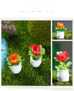 Detail of miniature dollhouse potted plants with realistic red and orange flowers