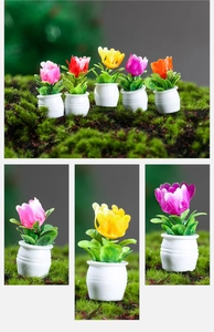 Close-up of miniature potted plants in various colors for dollhouse decoration