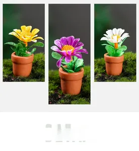 Detailed macro shot of three colorful miniature dollhouse potted plants on moss background