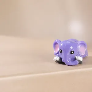 Macro shot of a cute purple resin elephant figurine for garden landscape decoration
