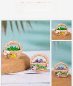 Detailed close-up of a miniature resin flower basket with succulent and bird accents