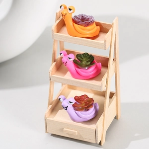 Set of 3 creative snail succulent planters with figurines on a mini wooden display stand