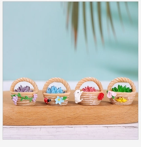 Macro shot of four miniature resin flower baskets with succulent models on wood base