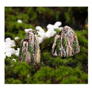 Macro shot of resin miniature rockery with realistic textures and faux green vegetation