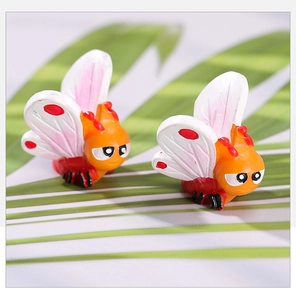 Detailed close-up of cute orange resin butterfly figurines for DIY garden landscaping