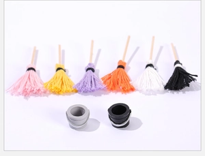 Detail of miniature colorful brooms and buckets for dollhouse scene decoration