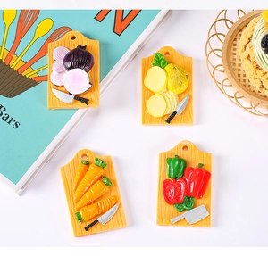 Close-up of resin refrigerator magnets featuring realistic vegetable and cutting board designs