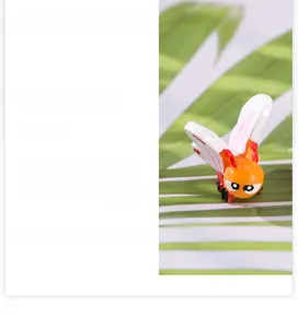 Detailed view of an orange resin cartoon butterfly ornament for garden micro-landscapes
