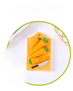Detail of creative resin fridge magnet featuring a carrot and cutting board design