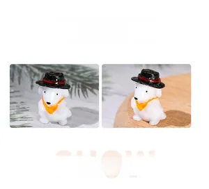 Close-up of resin puppy figurine with black hat and orange scarf for bonsai DIY