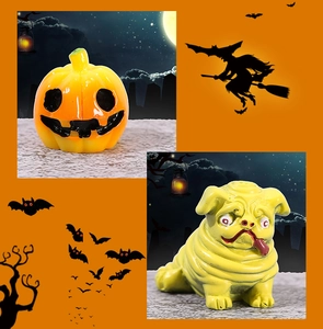 Macro detail of resin Halloween pumpkin and pug dog figurine for DIY ornaments