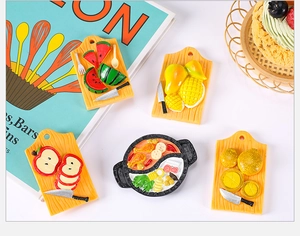 Detailed resin food miniatures of hot pot and sliced fruits on a mini cutting board