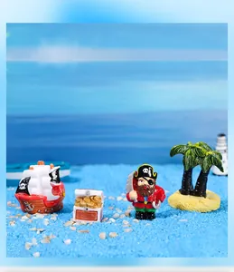 Miniature pirate ship set with treasure chest and captain figurine on blue sand decor
