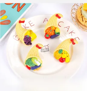 Detailed view of mini resin fruit baskets featuring grapes and bananas on a white ceramic plate