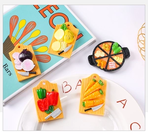 Macro view of miniature resin kitchen fridge magnets with vegetables and cutting boards