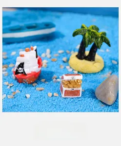 Miniature pirate ship set with treasure chest and coconut trees on blue sand scenery